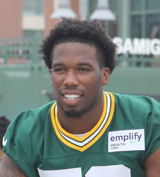 Packers linebacker Edgerrin Cooper smiling at training camp.