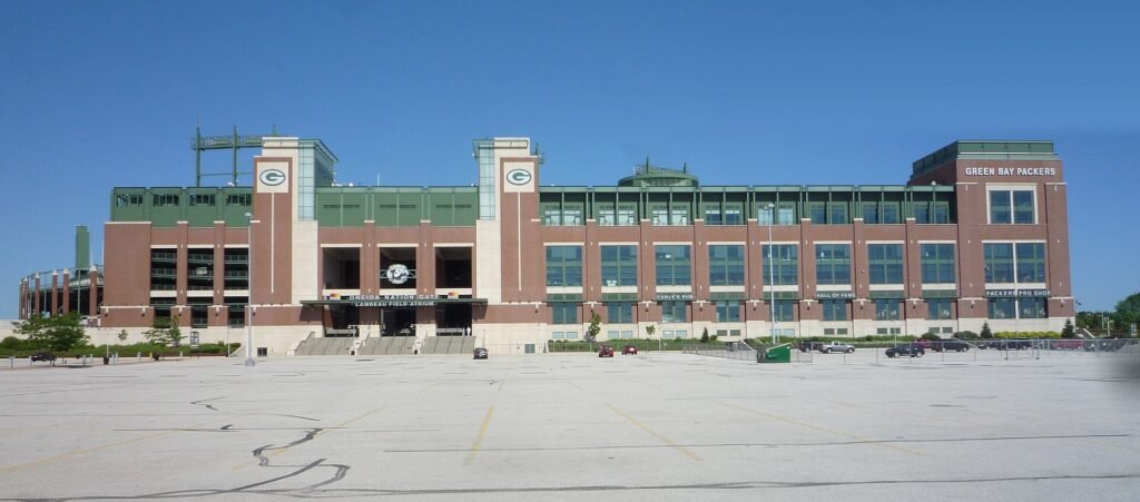 The brick exterior of Lambeau Field, home of the Green Bay Packers, on a sunny day.