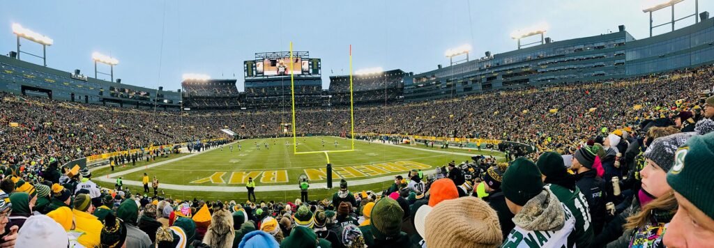 A packed crowd fills the stands at Lambeau Field during a Packers game.
