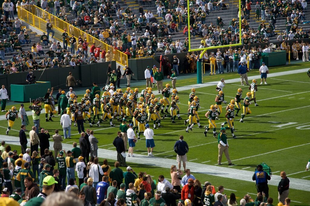 Packers players run onto the field at Lambeau Field before a game against the Falcons.